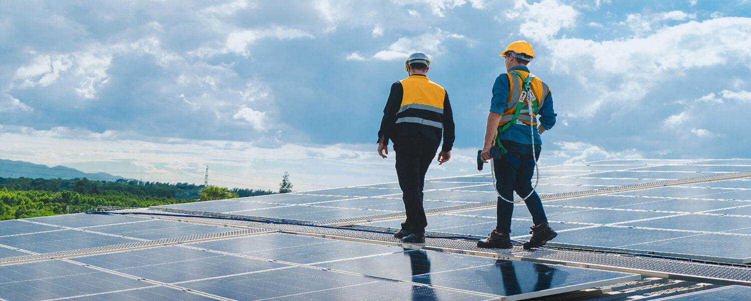 Construction crew servicing solar panels